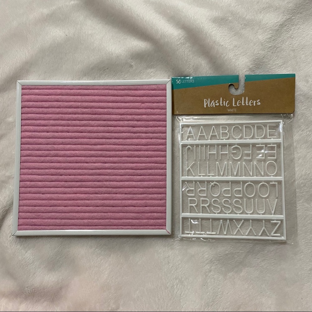 Pink letter board with white letters